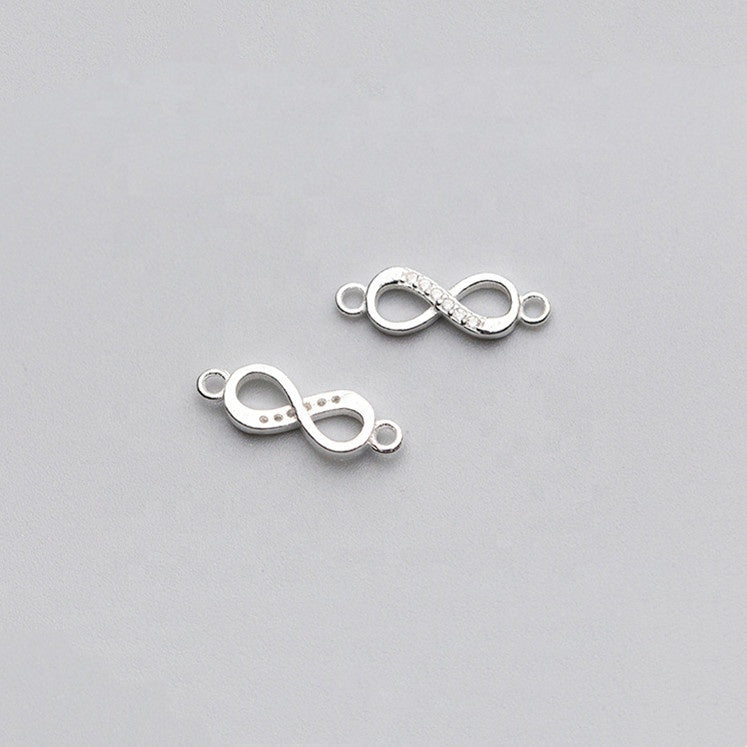 Two silver infinity symbol connectors on a light gray background