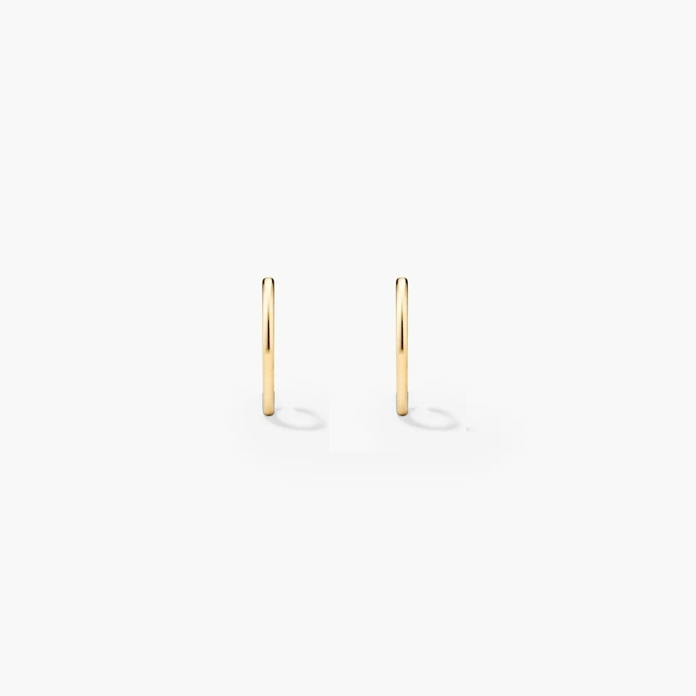 Gold endless hoop earrings on a white background