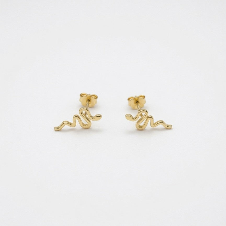 Gold Snake Shaped Sud Earrings On  White Backround  