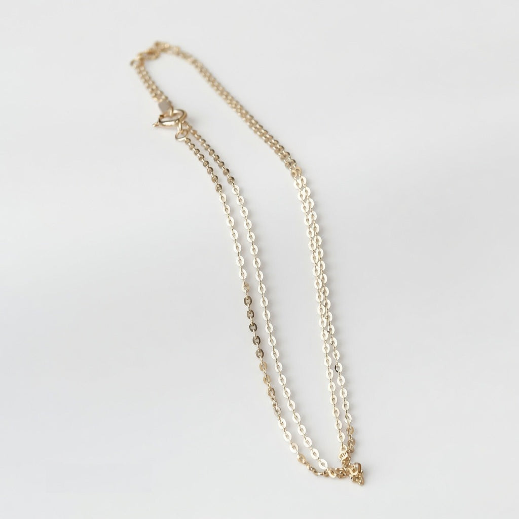 14ct solid gold cable chain necklace on a light background