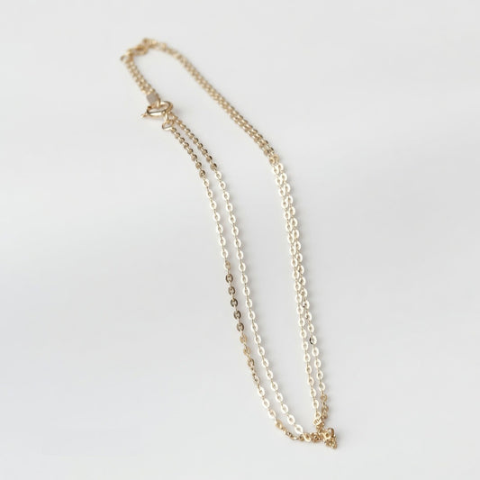 14ct solid gold cable chain necklace on a light background