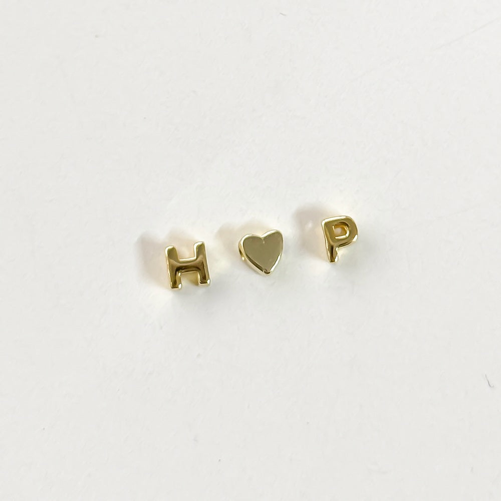 gold H letter slider bead gold heart slider bead gold P letter slider bead a white background