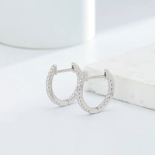 925 sterling silver crystal hoop earrings with cubic zirconia stones on white marble background