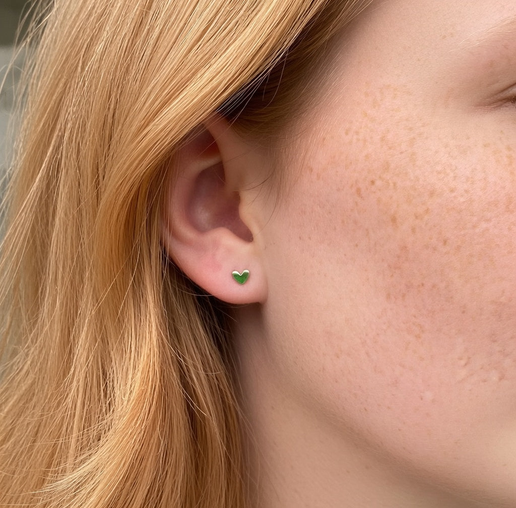 Dainty 925 sterling silver mini heart stud earrings worn on ear Agnes and Simon
