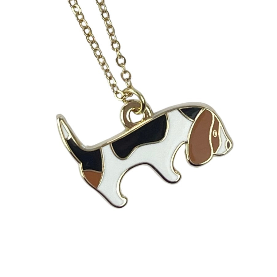 Dog-shaped pendant on a chain against a white background
