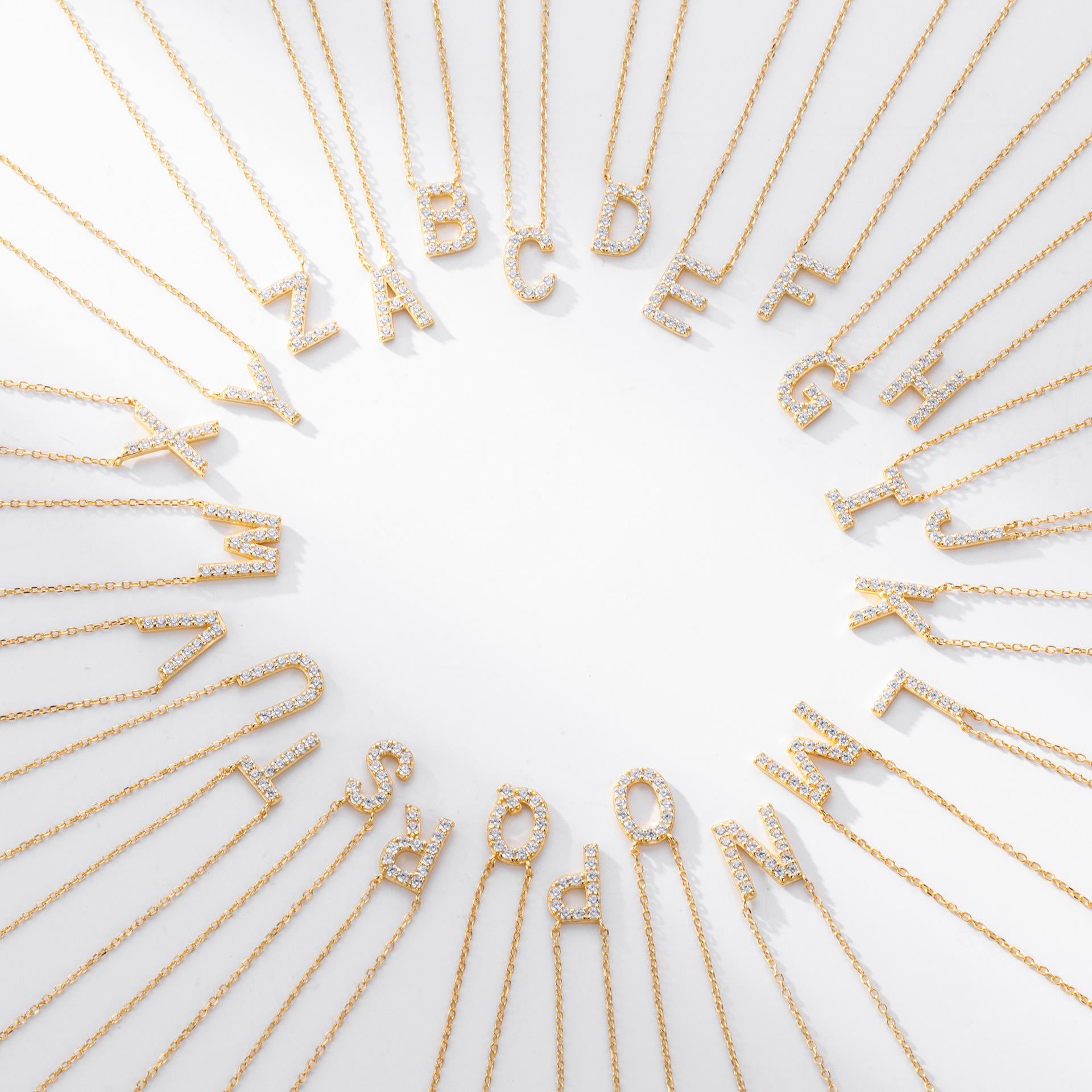 A-Z gold crystal initial letters necklaces on white background