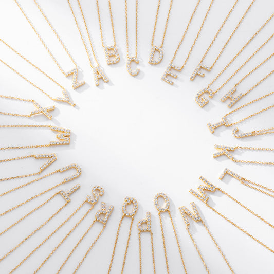 A-Z gold crystal initial letters necklaces on white background