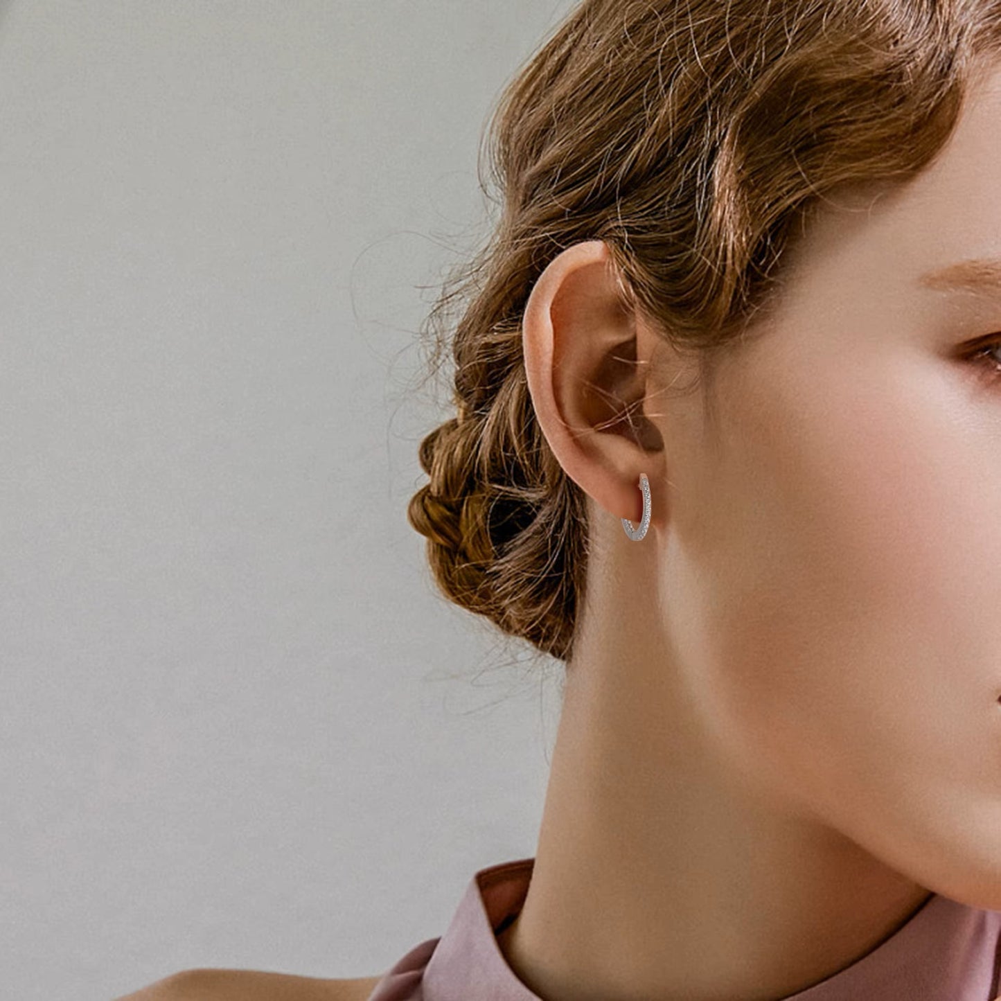Woman wearing 925 sterling silver crystal hoop earrings with cubic zirconia stones