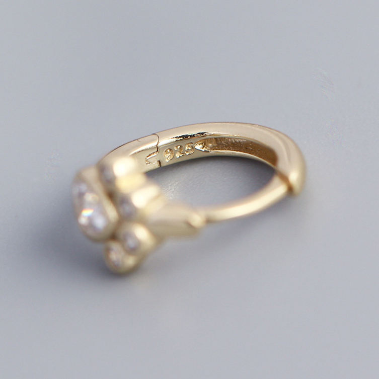 Gold paw earrings with a 925 stamp for sterling on a gray background