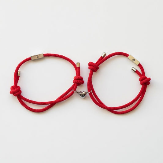 Red rope matching couple bracelet set with magnetic heart charm, sun and moon charms, adjustable sliding knot, on white background