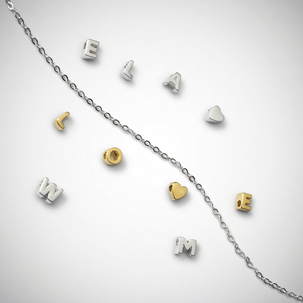 925 sterling silver and gold plated initial letter slider charm beads collection on a white background