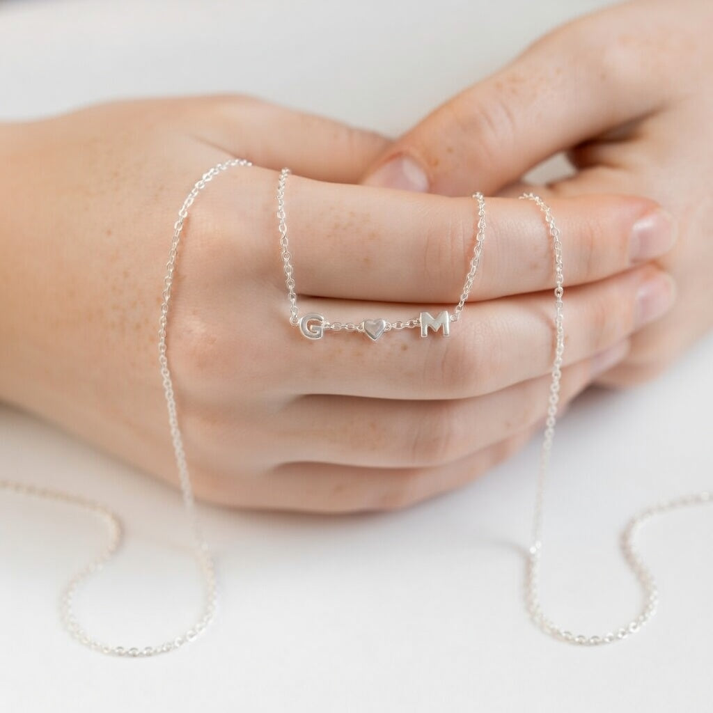 925 sterling silver initial letter slider charms on a necklace worn on hands